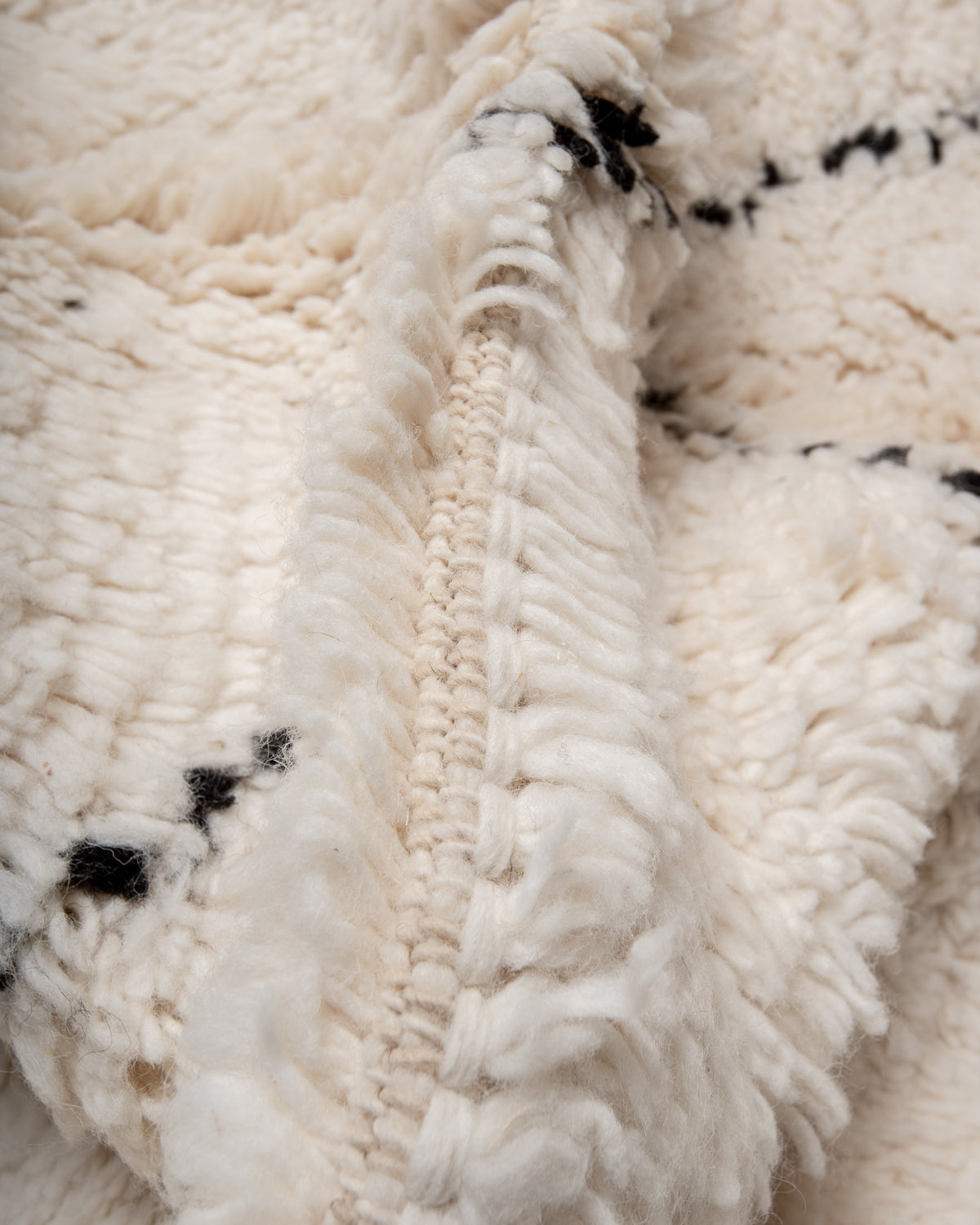 Modern, designer, handcrafted Berber rug from Morocco. Beniourain carpet with minimalist design, natural wool pile and a fluffy texture.