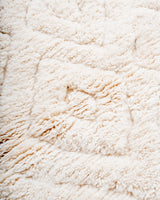 Modern, designer, handcrafted Berber rug from Morocco. Beniourain carpet with minimalist design, natural wool pile and a fluffy texture.