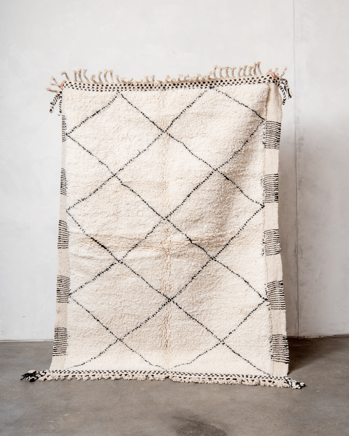 Modern, designer, handcrafted Berber rug from Morocco. Beniourain carpet with minimalist design, natural wool pile and a fluffy texture.
