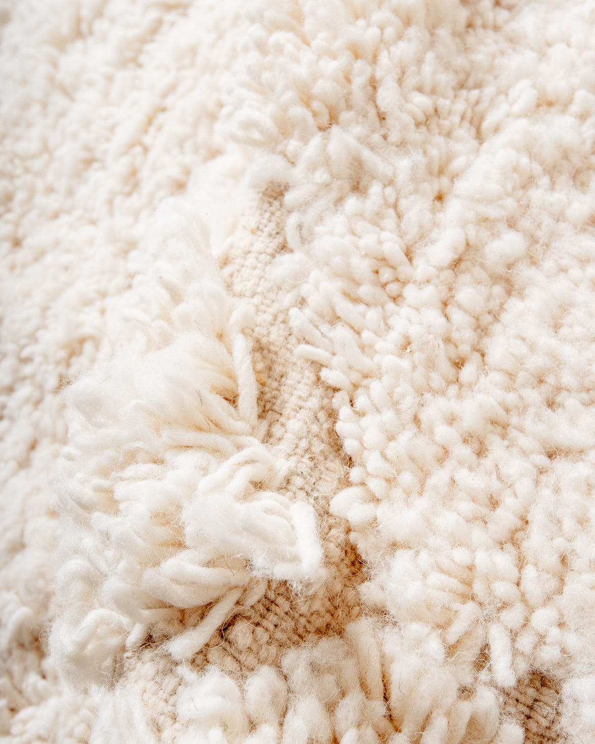 Modern, designer, handcrafted Berber rug from Morocco. Beniourain carpet with minimalist design, natural wool pile and a fluffy texture.