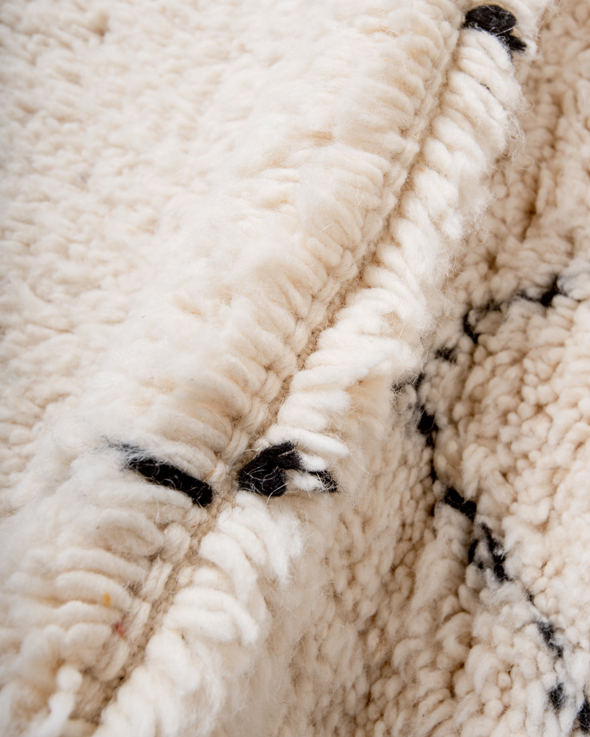 Modern, designer, handcrafted Berber rug from Morocco. Beniourain carpet with minimalist design, natural wool pile and a fluffy texture.