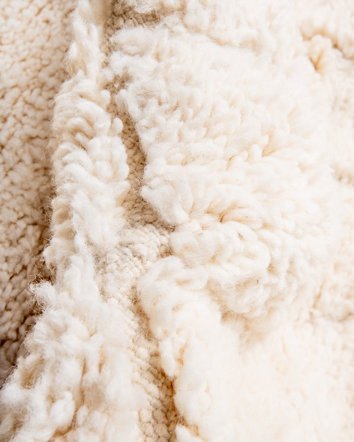 Modern, designer, handcrafted Berber rug from Morocco. Beniourain carpet with minimalist design, natural wool pile and a fluffy texture.