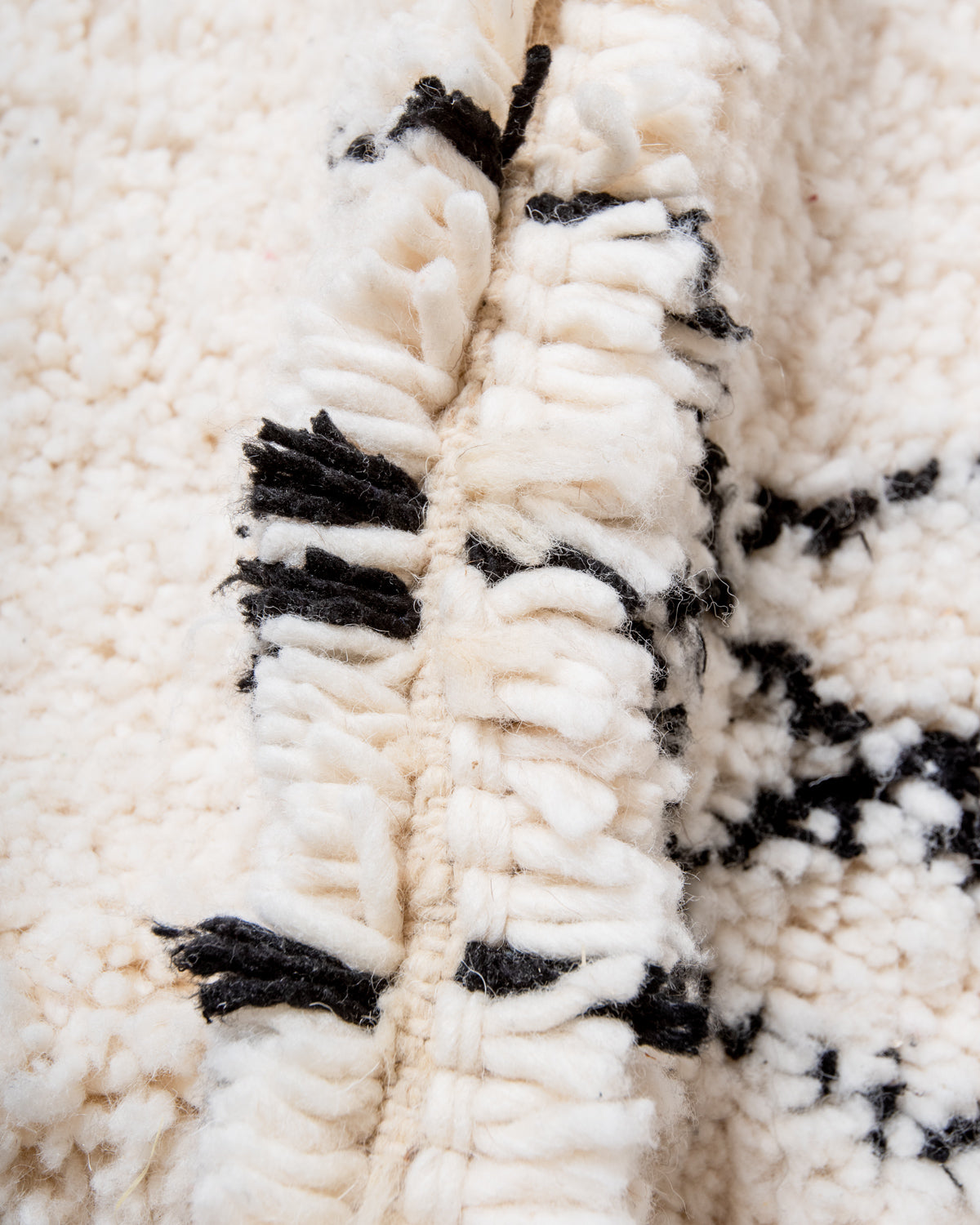 Modern, designer, handcrafted Berber rug from Morocco. Beniourain carpet with minimalist design, natural wool pile and a fluffy texture.