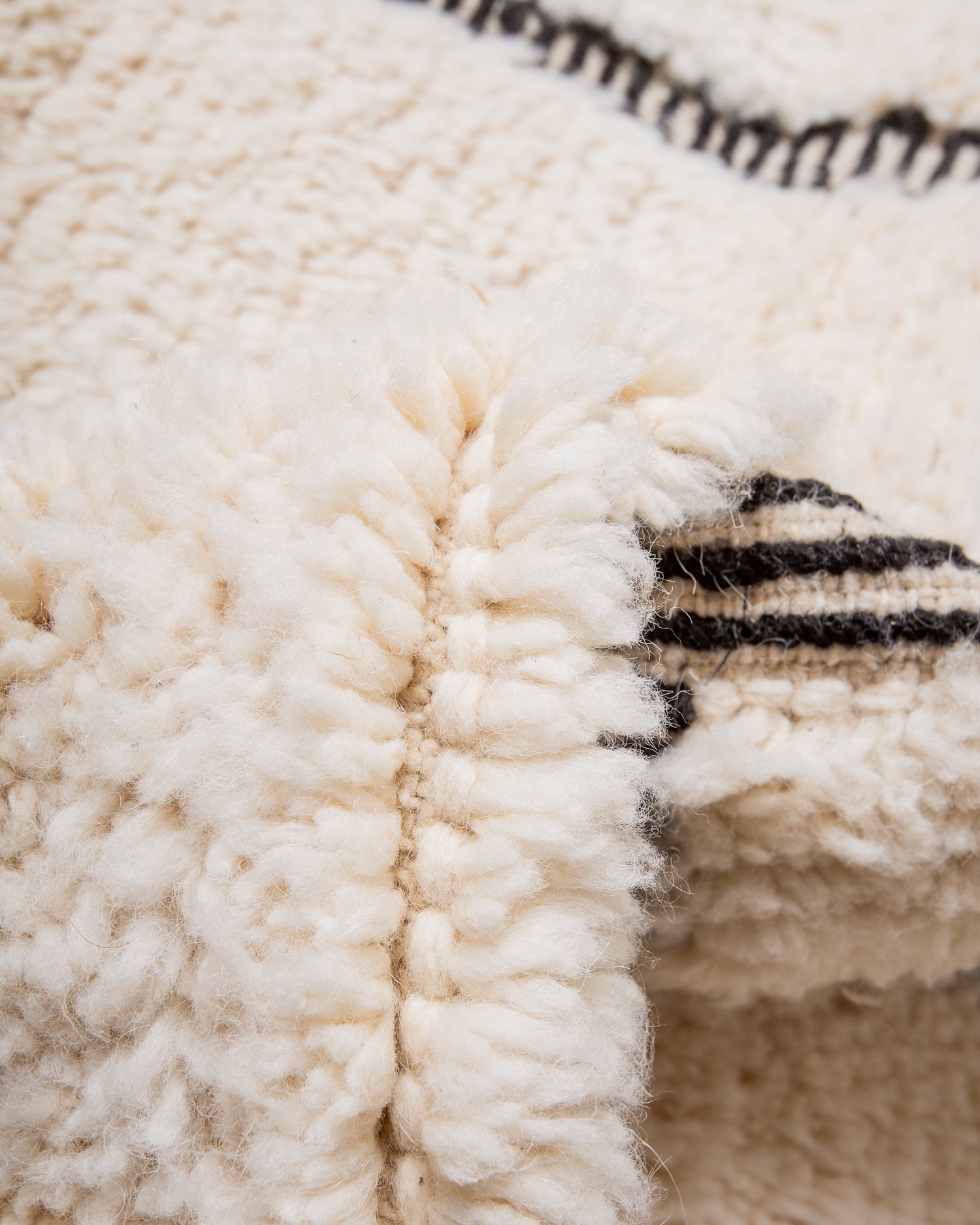 Modern, designer, handcrafted Berber rug from Morocco. Beniourain carpet with minimalist design, natural wool pile and a fluffy texture.