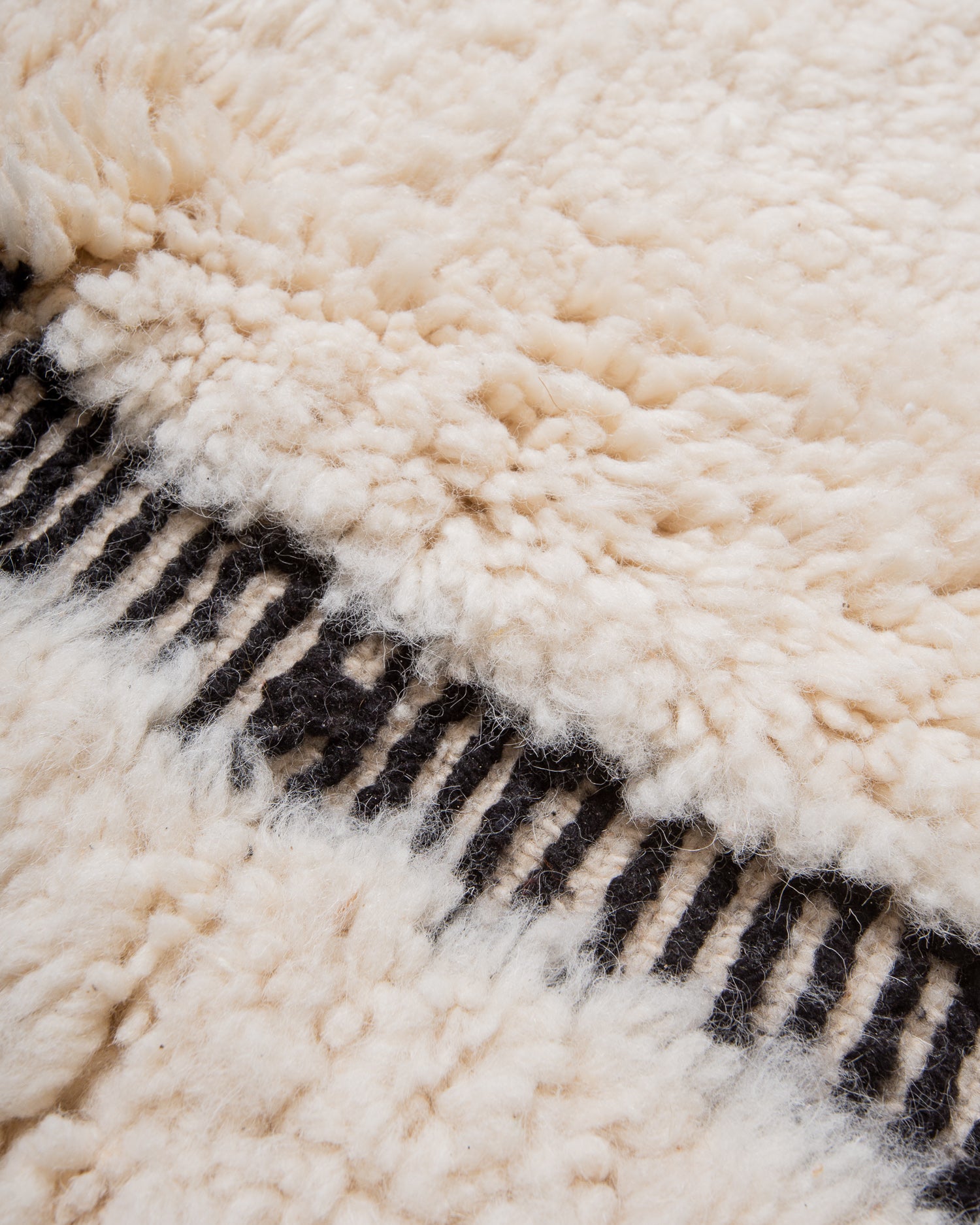 Modern, designer, handcrafted Berber rug from Morocco. Beniourain carpet with minimalist design, natural wool pile and a fluffy texture.