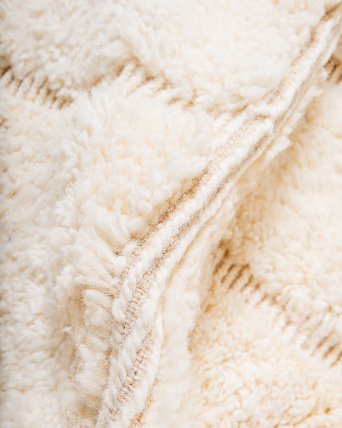 Close up of cream wool Beniourain rug.