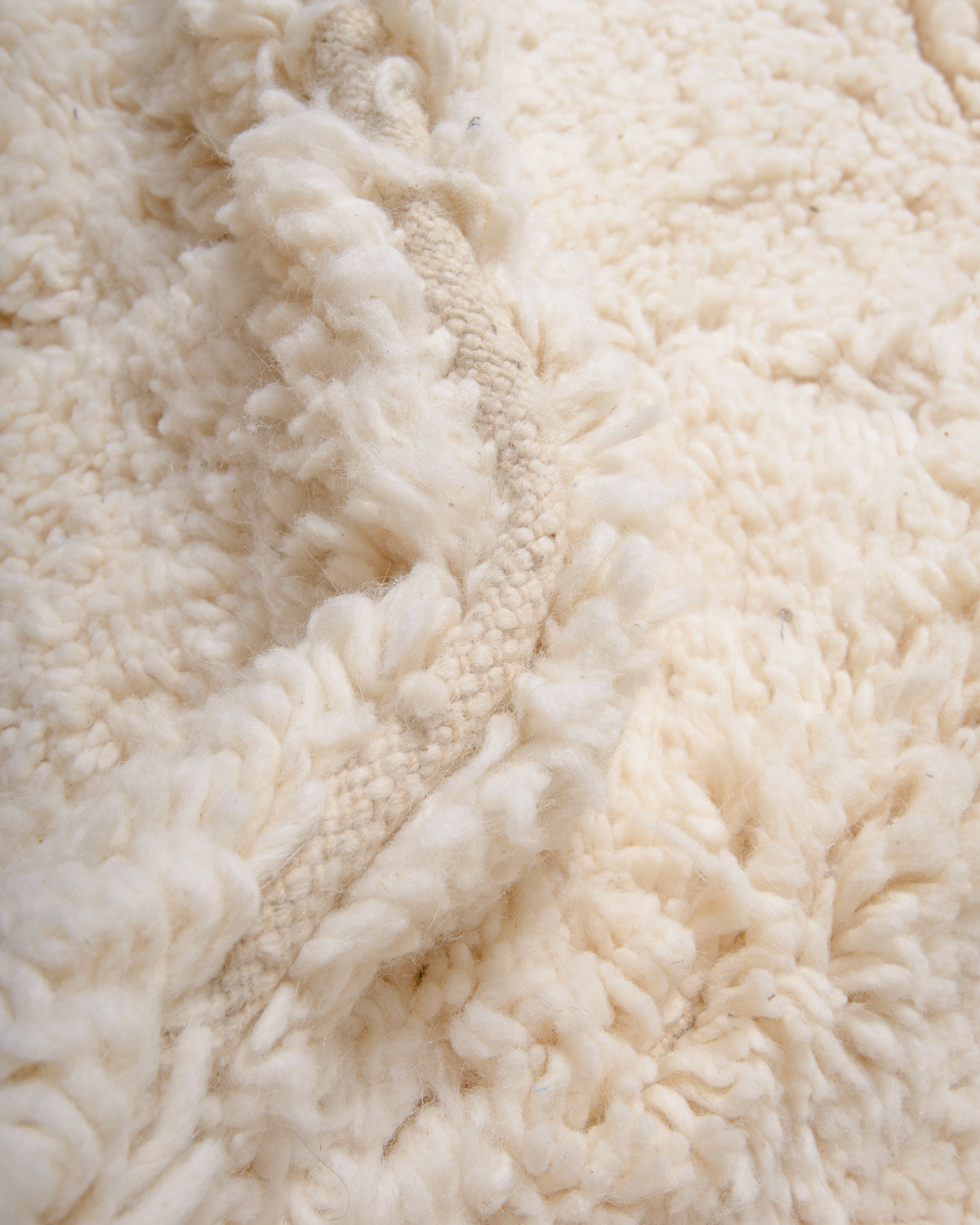 Modern, designer, handcrafted Berber rug from Morocco. Beniourain carpet with minimalist design, natural wool pile and a fluffy texture.