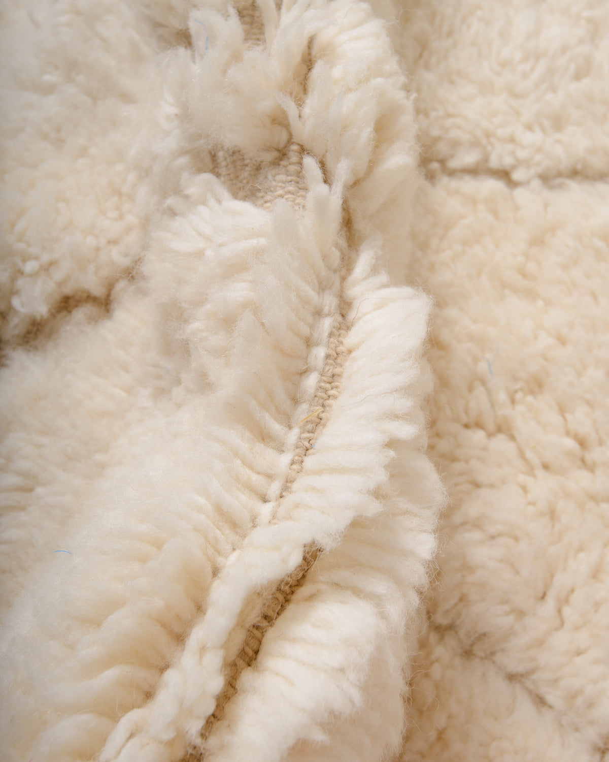 Modern, designer, handcrafted Berber rug from Morocco. Beniourain carpet with minimalist design, natural wool pile and a fluffy texture.