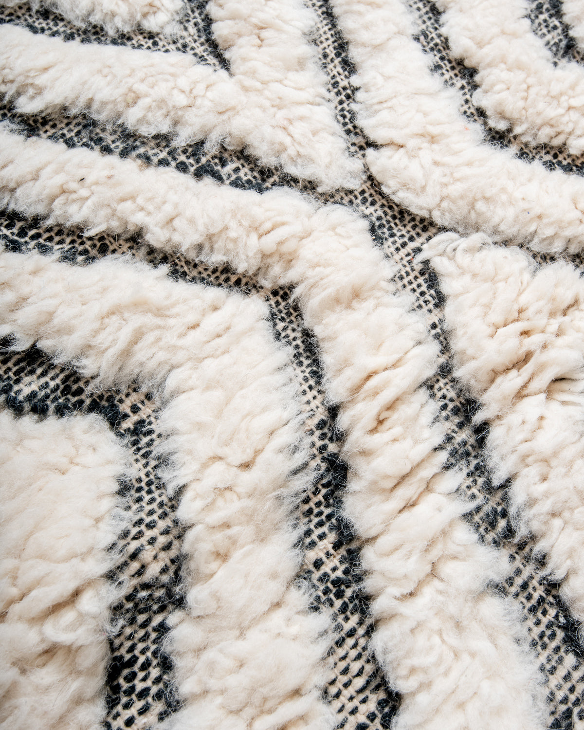 Modern, designer, handcrafted Berber rug from Morocco. Beniourain carpet with minimalist design, natural wool pile and a fluffy texture.