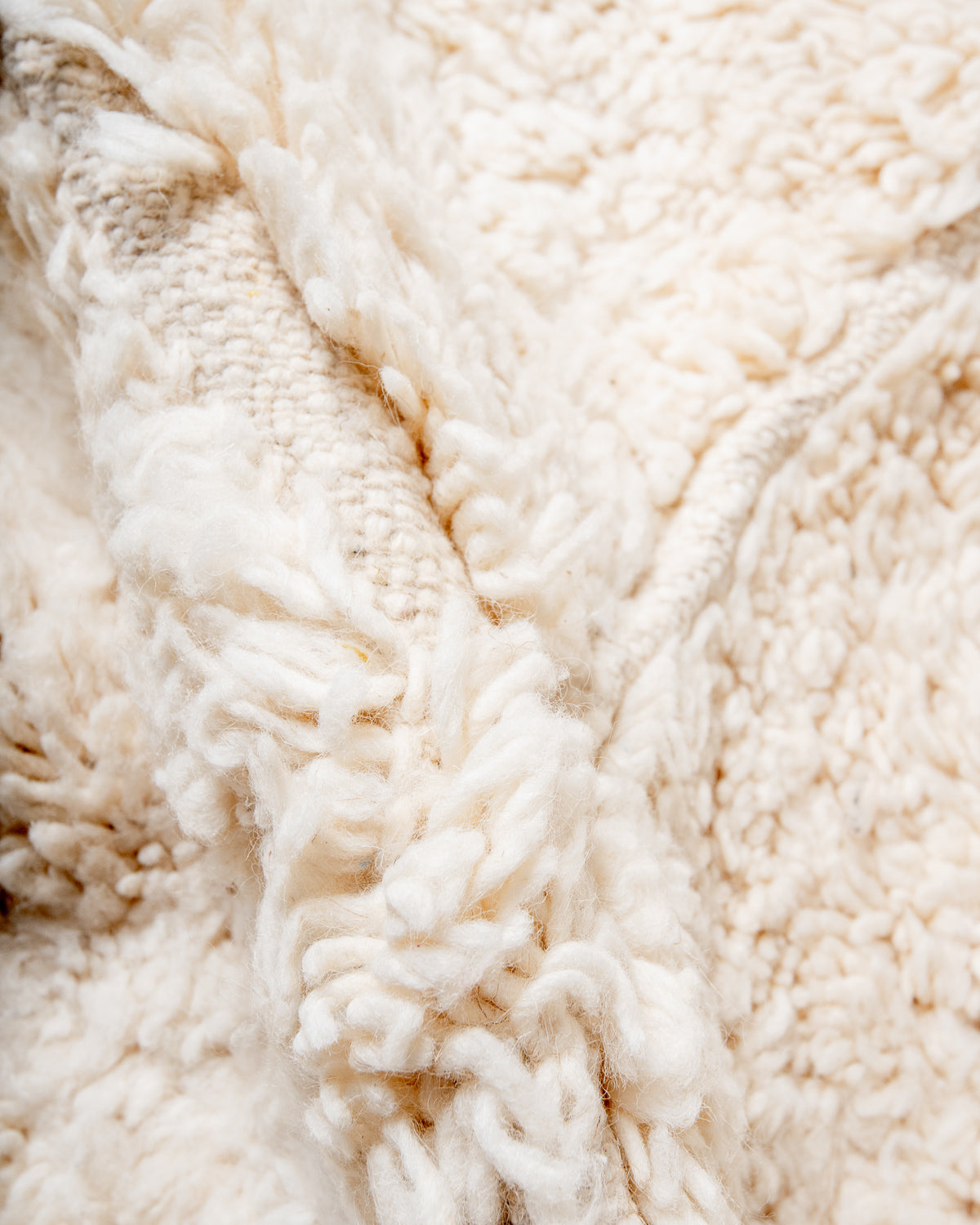 Modern, designer, handcrafted Berber rug from Morocco. Beniourain carpet with minimalist design, natural wool pile and a fluffy texture.