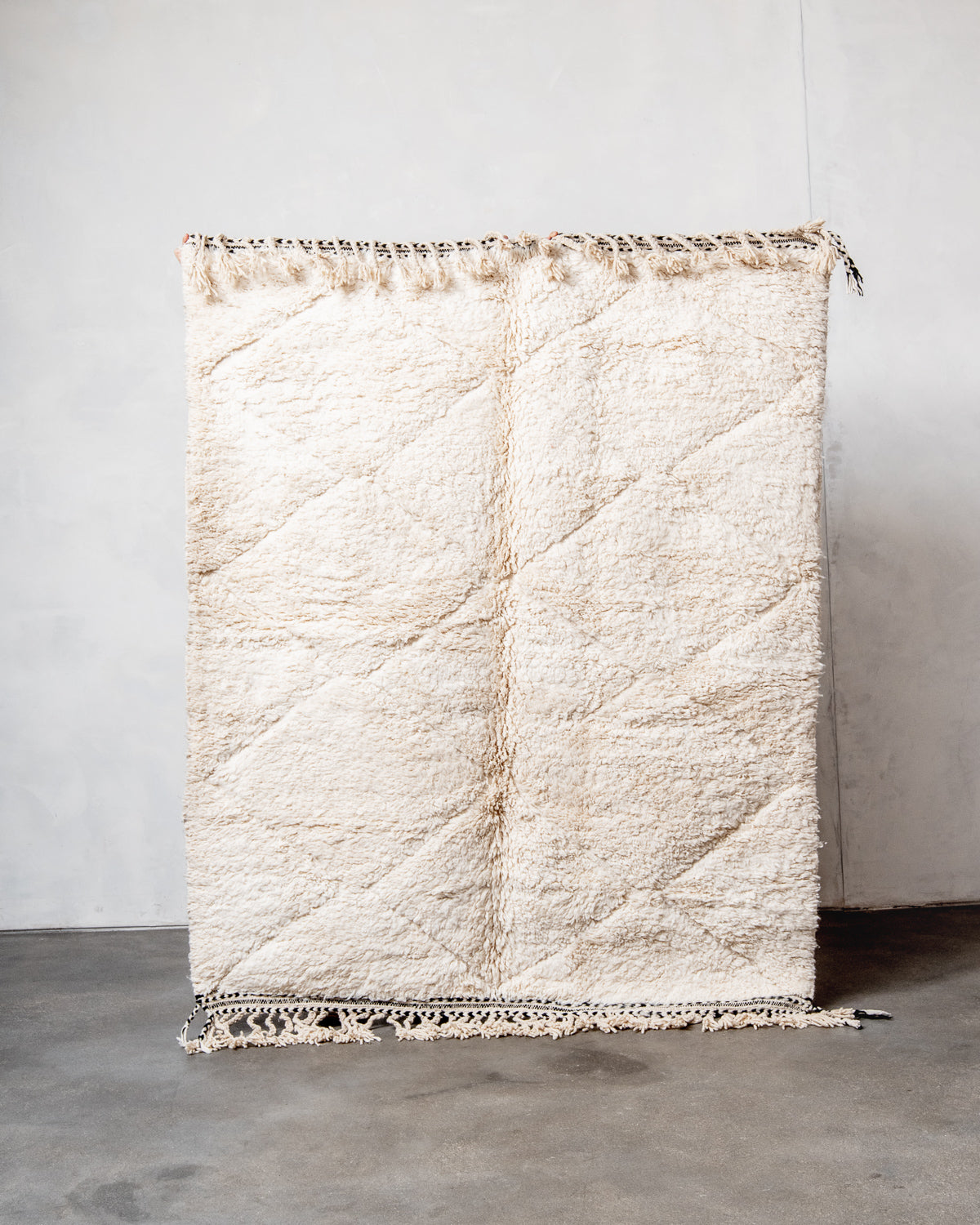 Modern, designer, handcrafted Berber rug from Morocco. Beniourain carpet with minimalist design, natural wool pile and a fluffy texture.