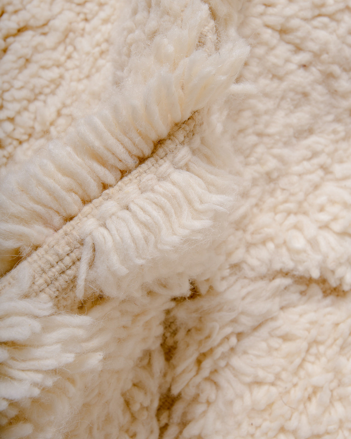 Close up of cream wool rug.