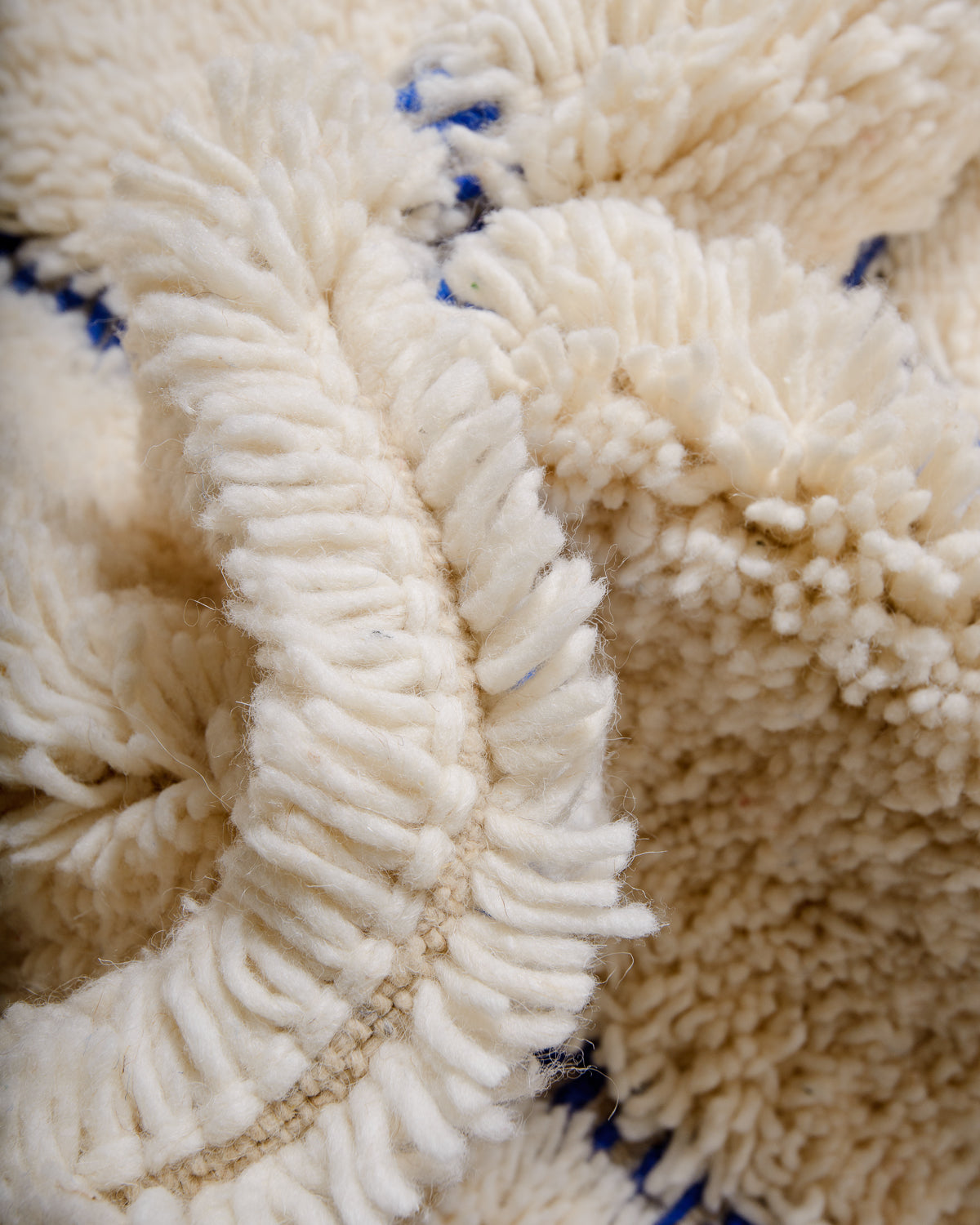 Modern, designer, handcrafted Berber rug from Morocco. Beniourain carpet with minimalist design, natural wool pile and a fluffy texture.