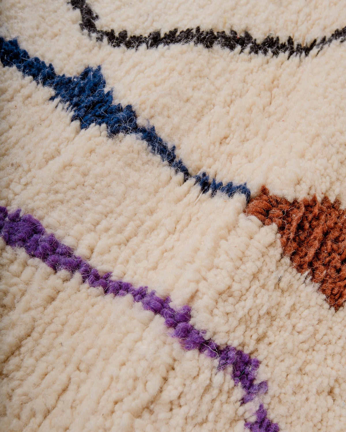 Modern, designer, handcrafted Berber rug from Morocco. Beniourain carpet with beautiful colours and patterns and fluffy wool texture.