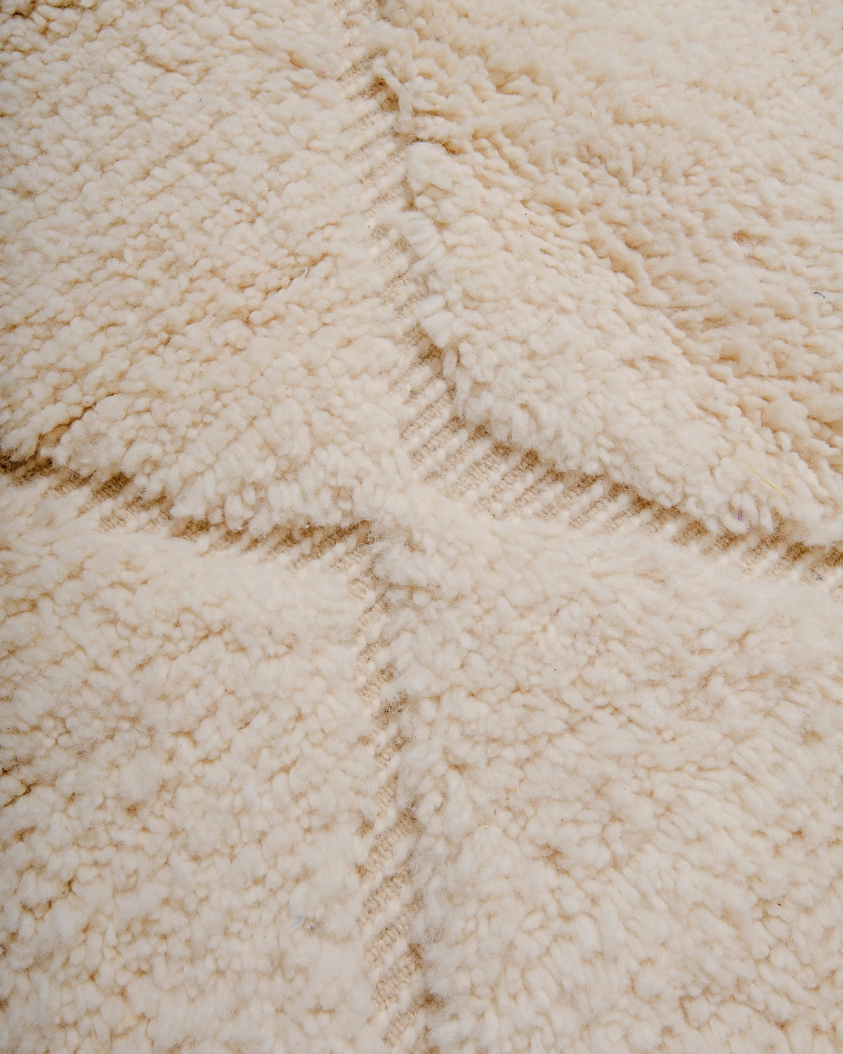 Detail of Berberlin Beniourain Rug made of natural cream wool.