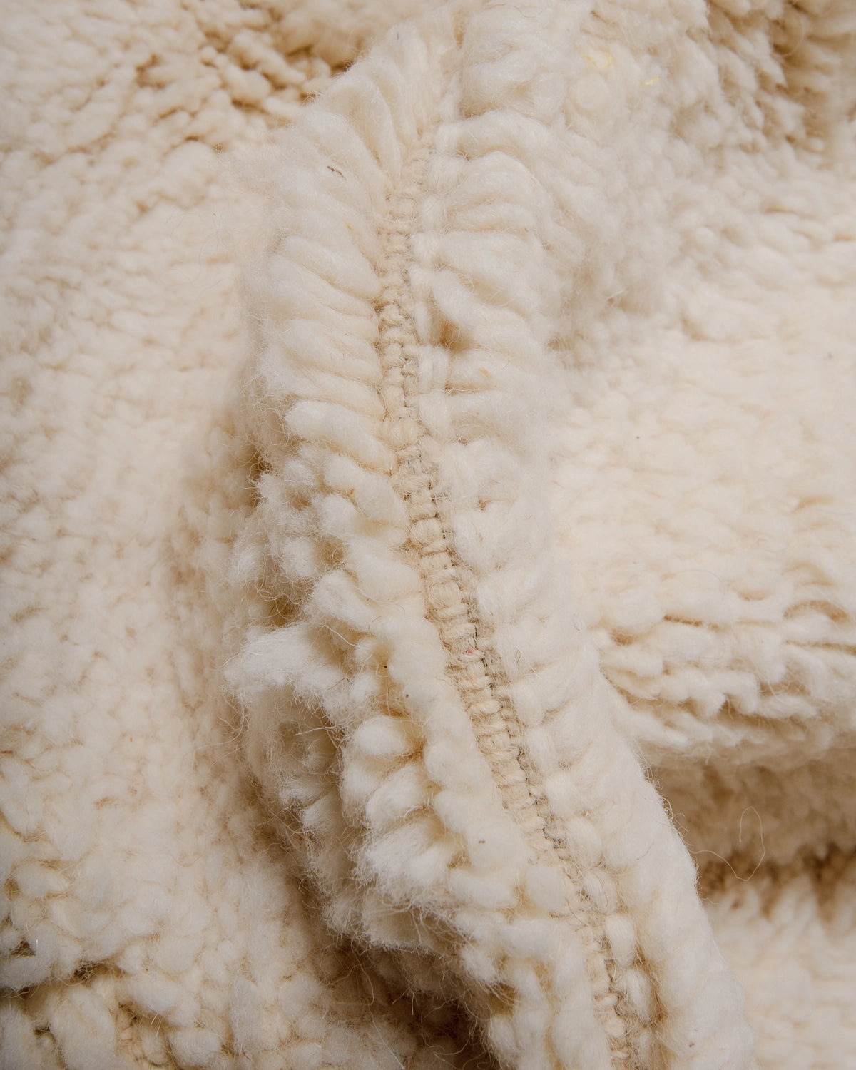 Detail of Berberlin Beniourain Rug made of natural cream wool.