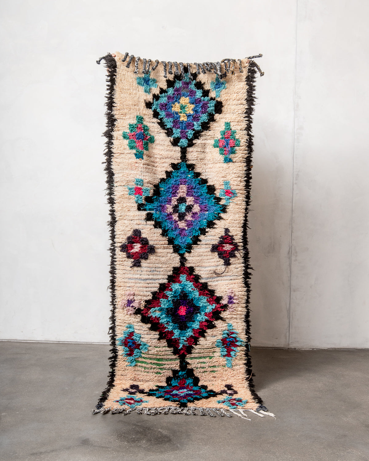 Modern designer vintage handcrafted Berber rug from Morocco. Boucherouite runner rug with beautiful colors and patterns.
