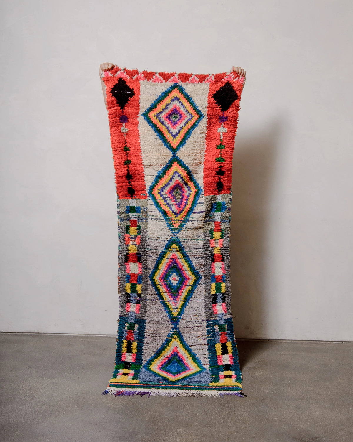 Berberlin Vintage Berber Rug in shades of red, cream, grey and blue with coloured diamond motifs in the center.