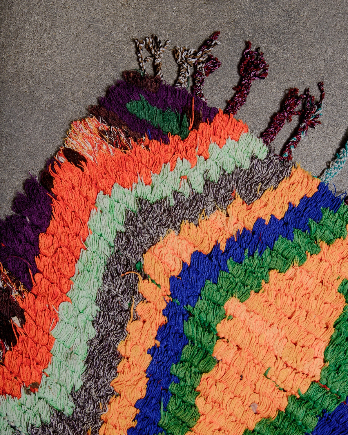 Cotton tassels on Berberlin Vintage Runner Rug made of recycled cloth and yarn in bright colours including blue, green, red and orange.