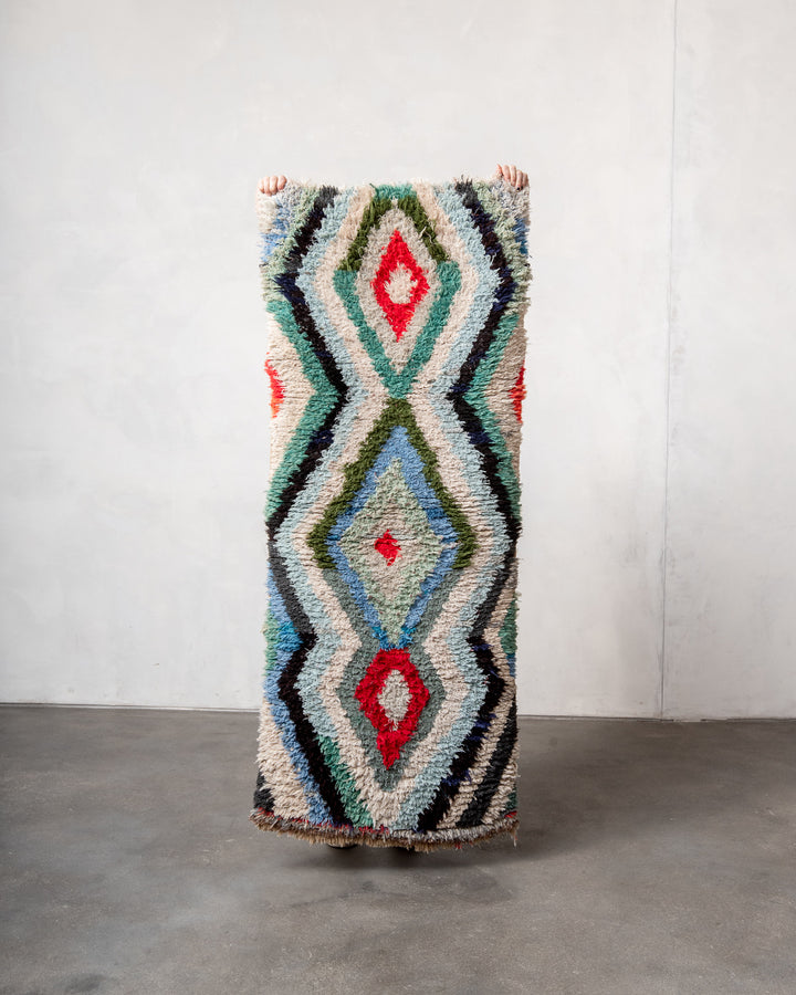Modern designer vintage handcrafted Berber rug from Morocco. Boucherouite runner rug with beautiful colors and patterns.