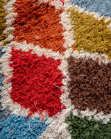 Modern designer vintage handcrafted Berber rug from Morocco. Boucherouite runner rug with beautiful colors and patterns.