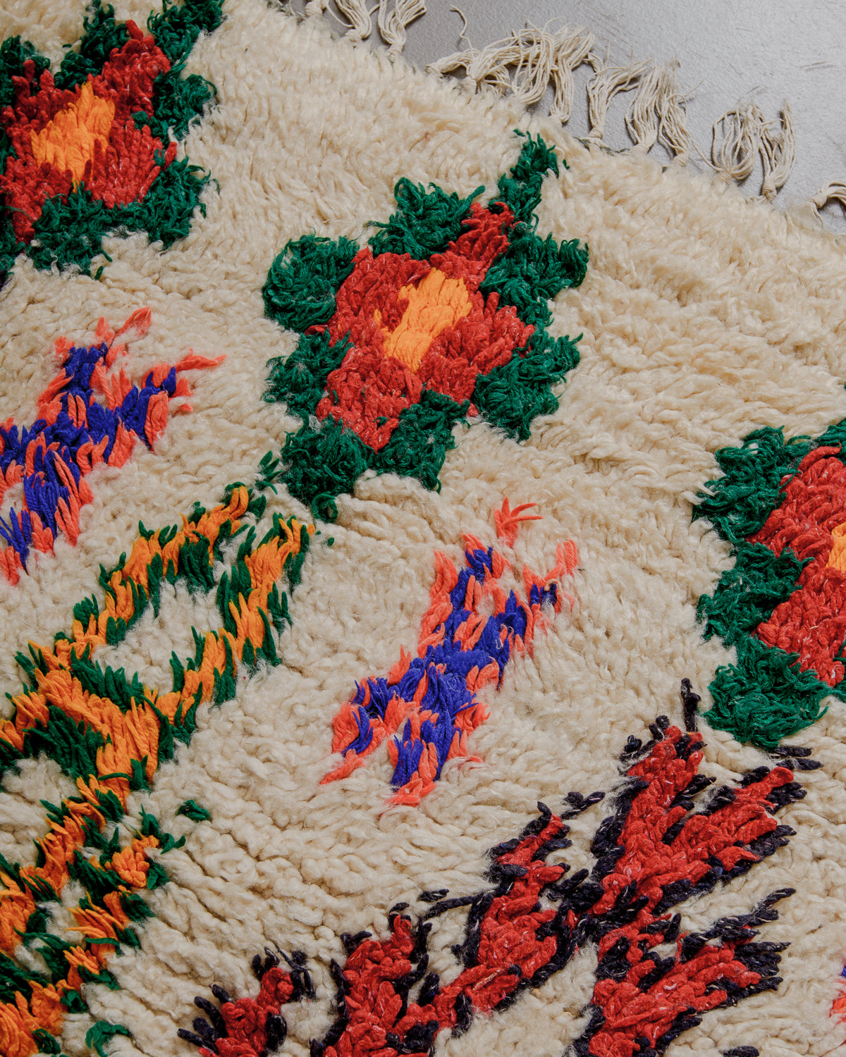 Close up of boucherouite rug surface with colourful cotton and cream wool.