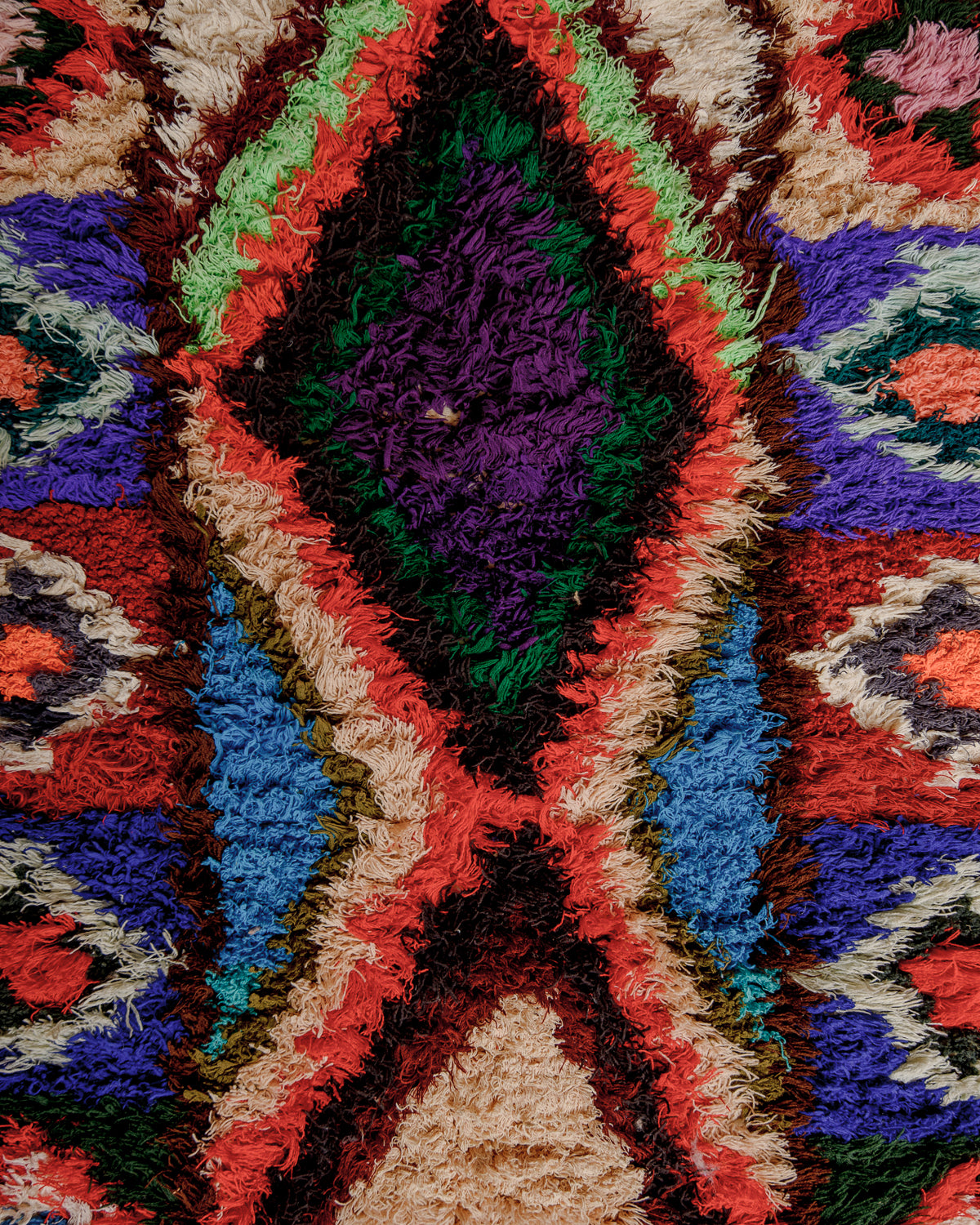 Close up of boucherouite rug surface with colourful cotton.