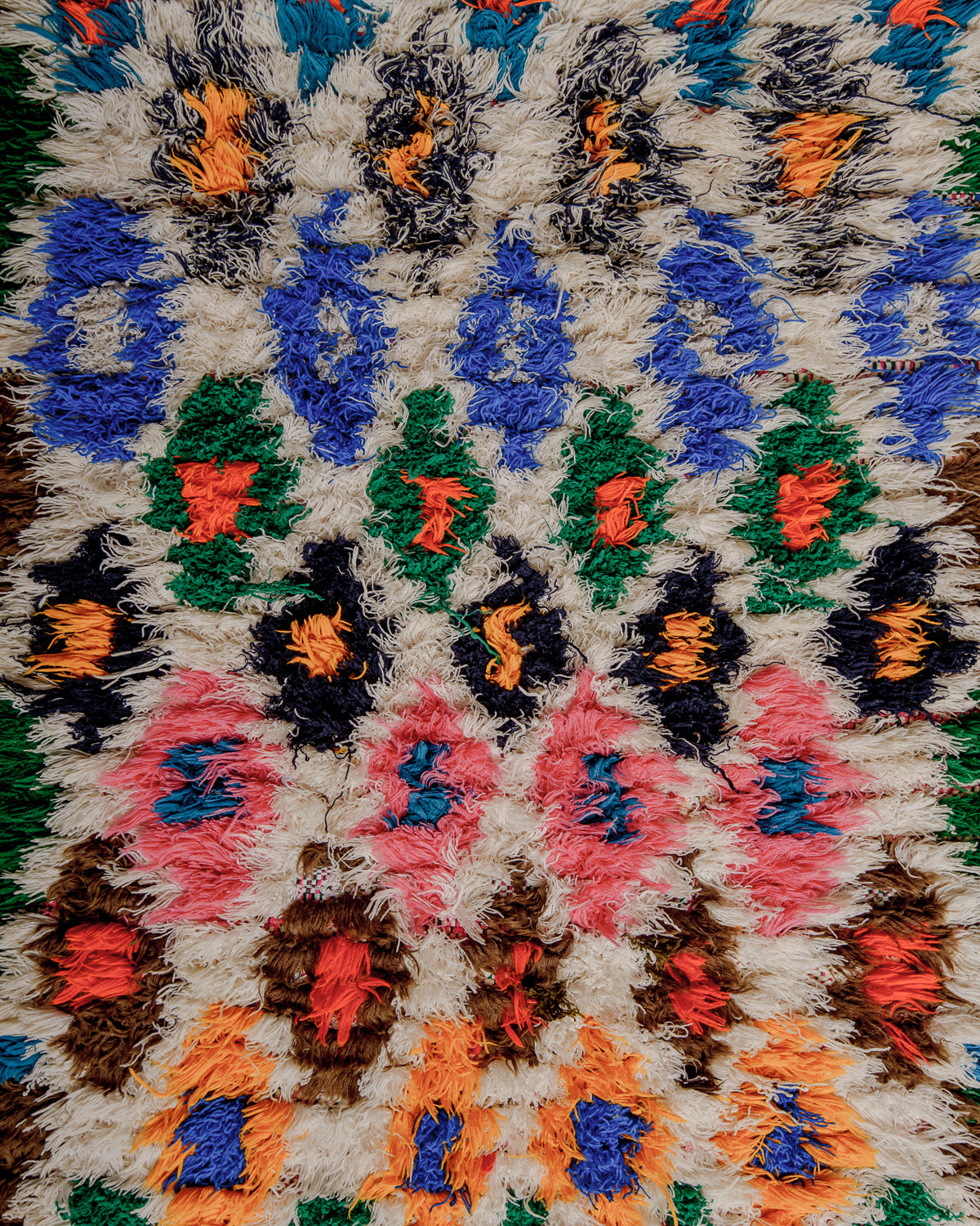 Close up of boucherouite rug surface with colourful cotton.