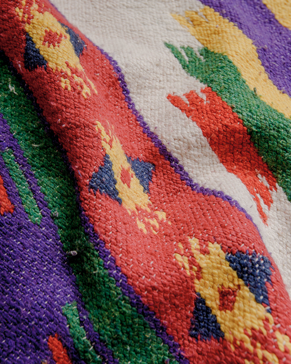 surface of boucherouite kelim rug made of colourful cotton.