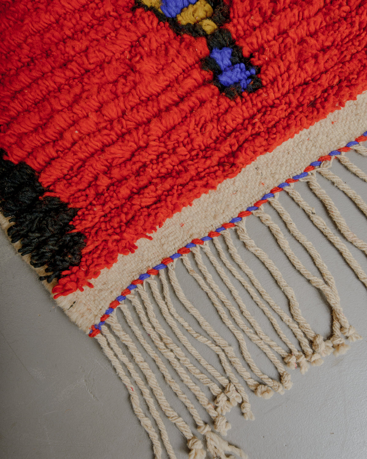 Corner of boujaad rug with natural wool tassels