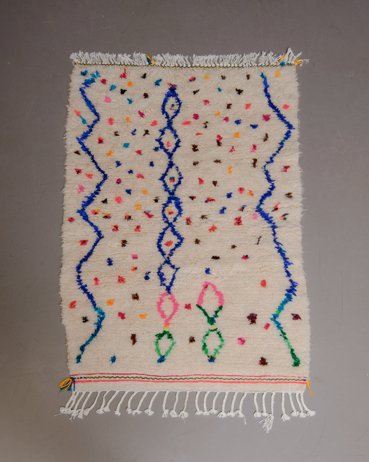 Small Berberlin Azilal rug on grey floor.