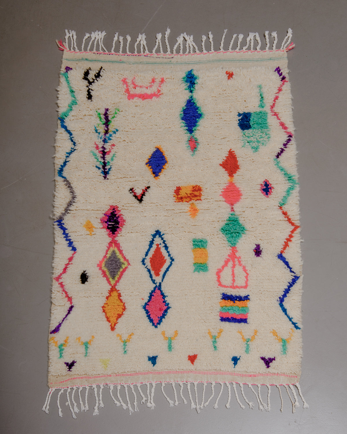 Small Berberlin Azilal rug on grey floor.
