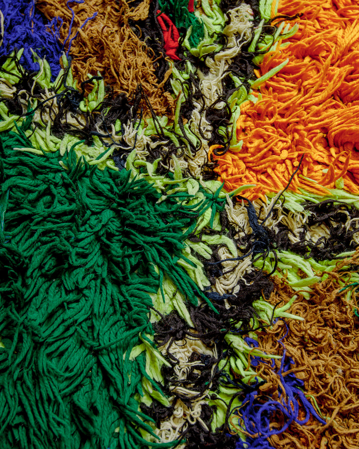 Close up of boucherouite rug surface with colourful cotton.