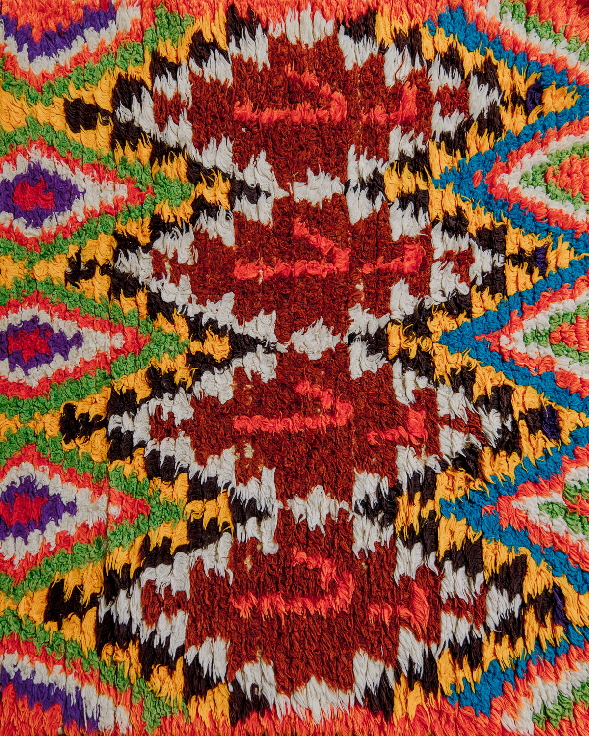 Close up of boucherouite rug surface with colourful cotton.