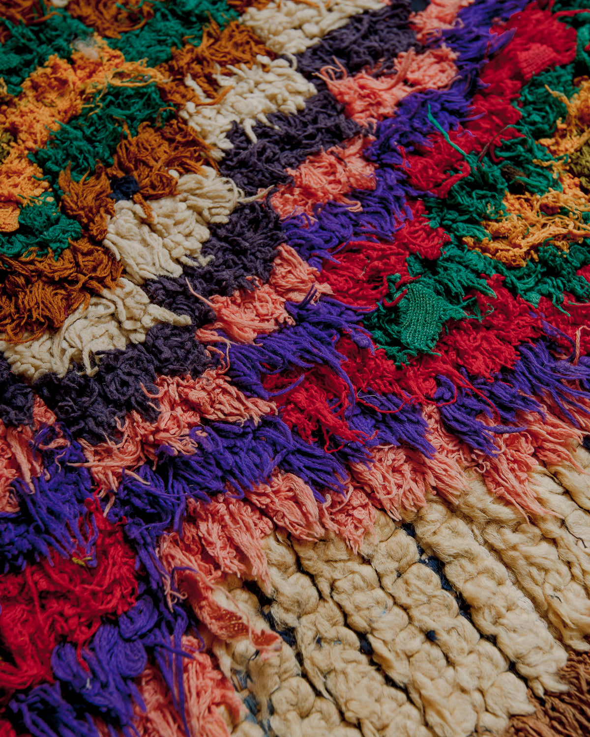 Close up of boucherouite rug surface with colourful cotton and beige wool.