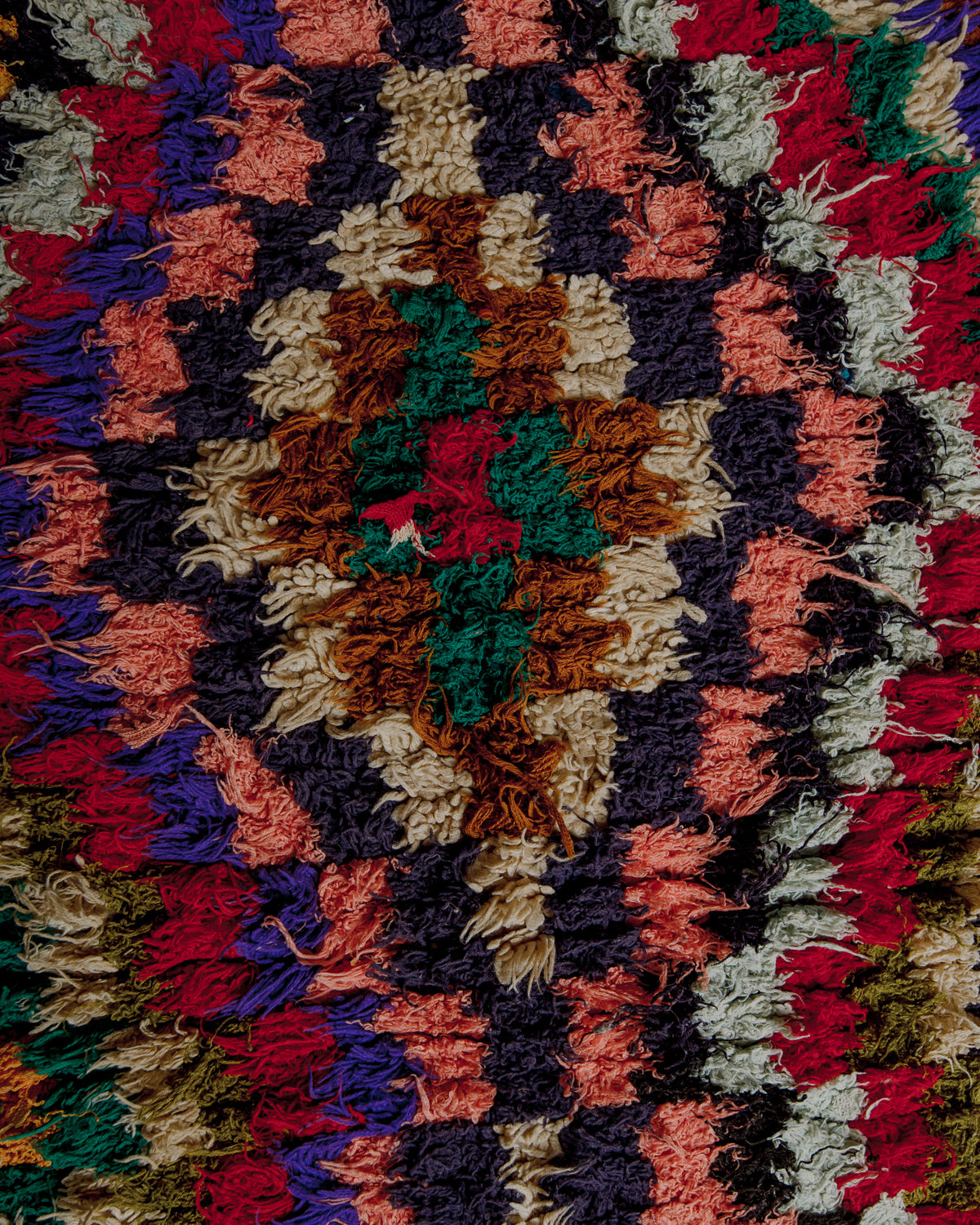 Close up of boucherouite rug surface with colourful cotton.