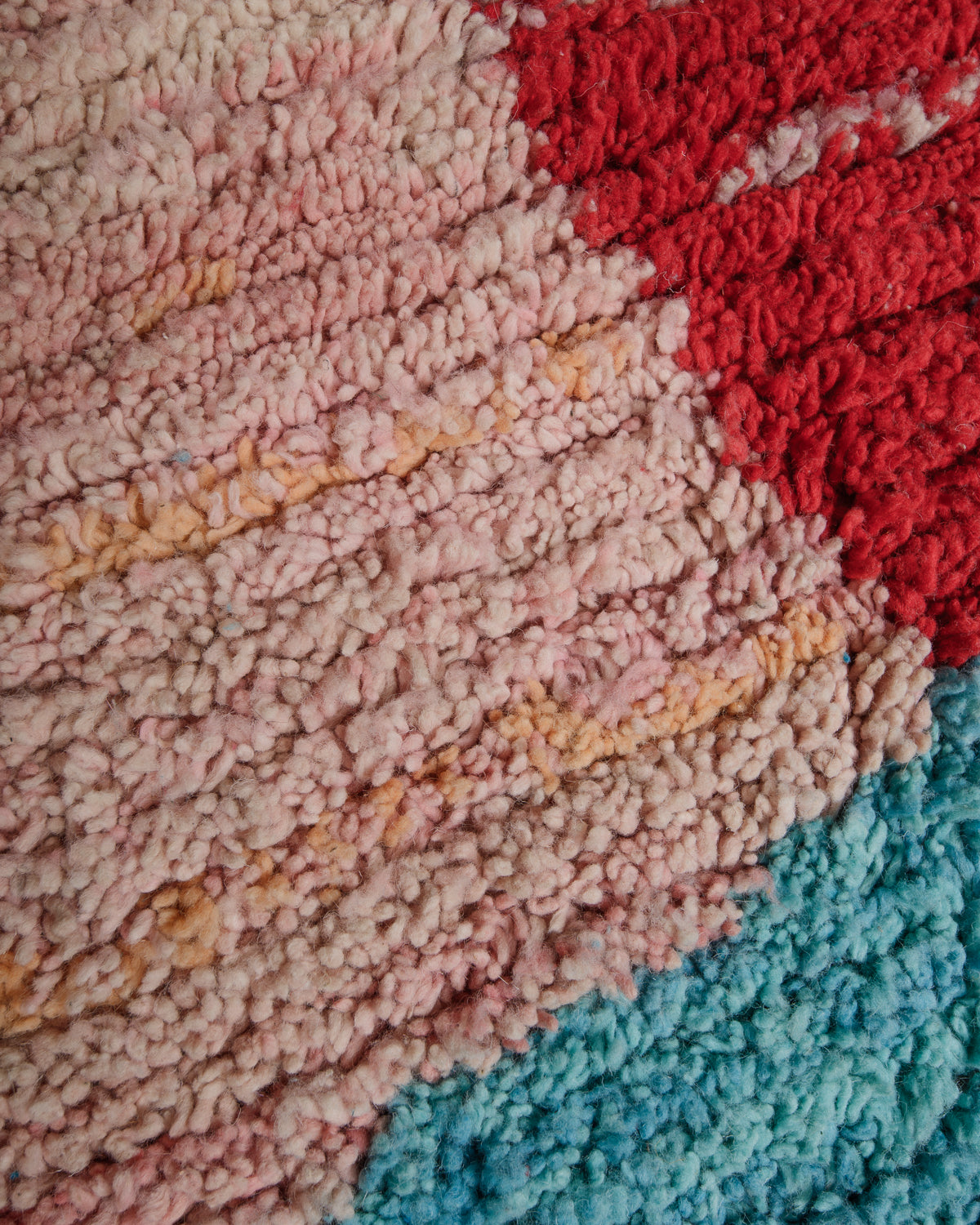 Close up of vintage boujaad rug showing the different shades of wool and surface texture.