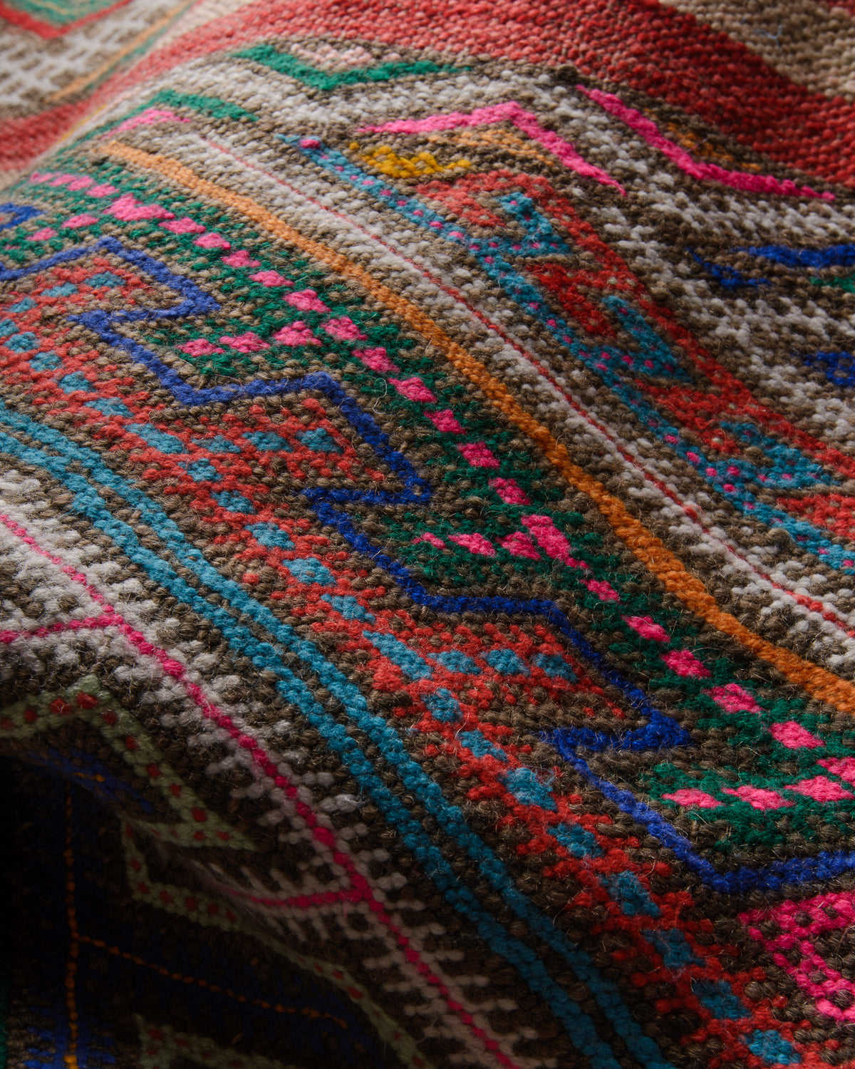 Detail of colourful vintage kelim rug.