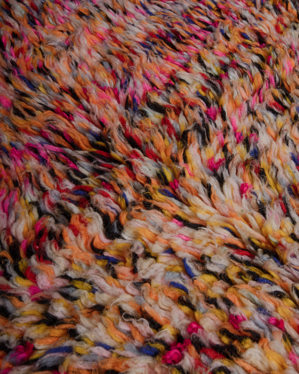 Texture of azilal rug made of multicoloured wool and cotton strands.