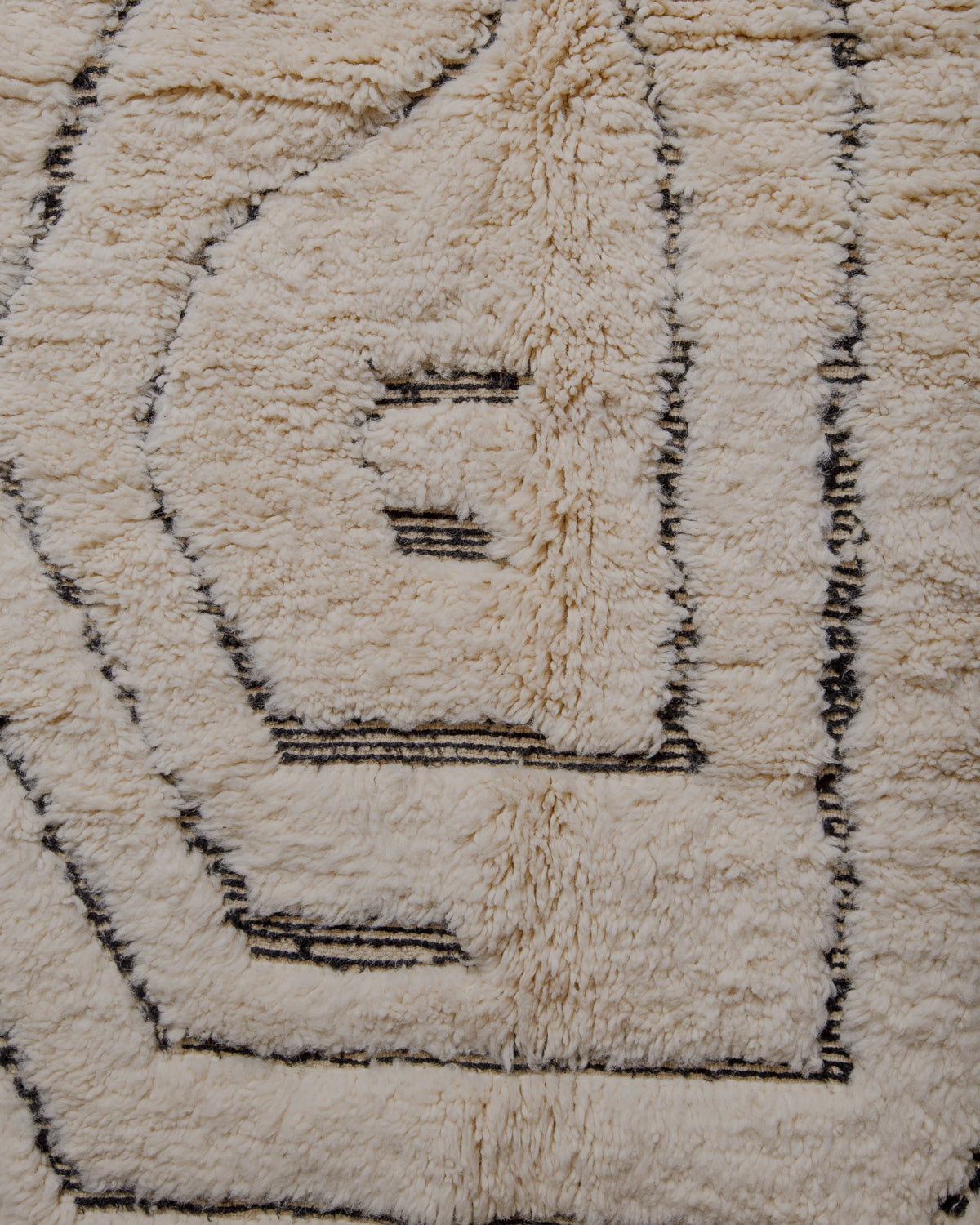 Fluffy cream wool pile with black striped details.