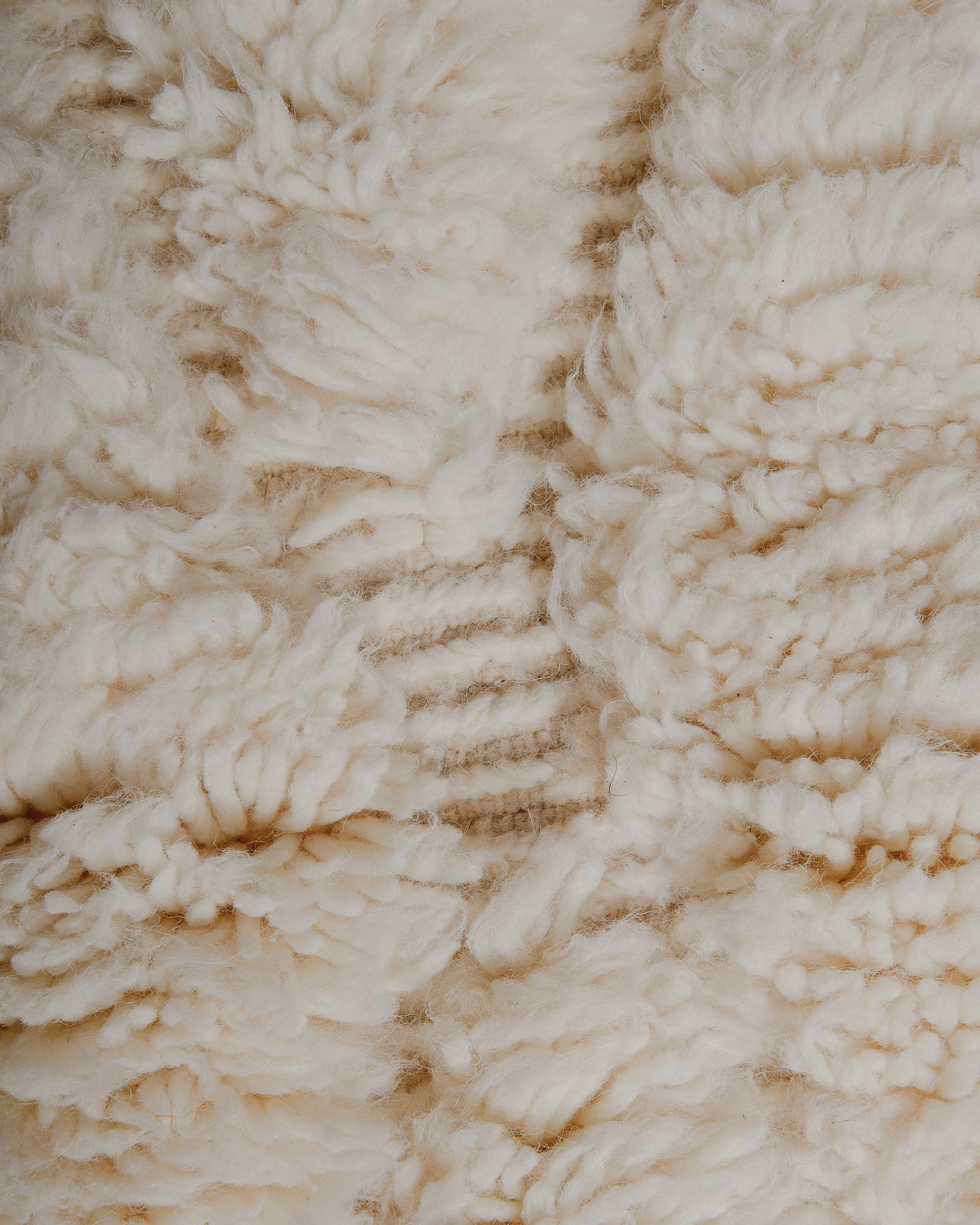 Fluffy cream wool pile and cream embroidered details.