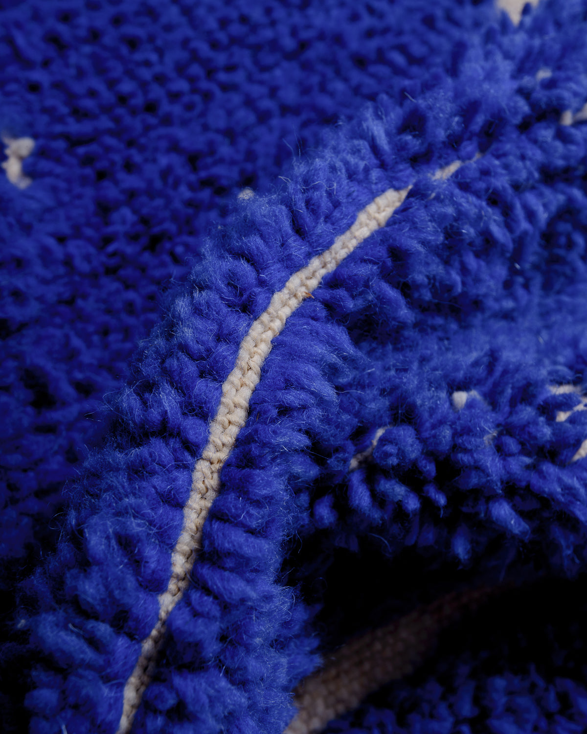 Detail of blue wool rug showing density of knots. 