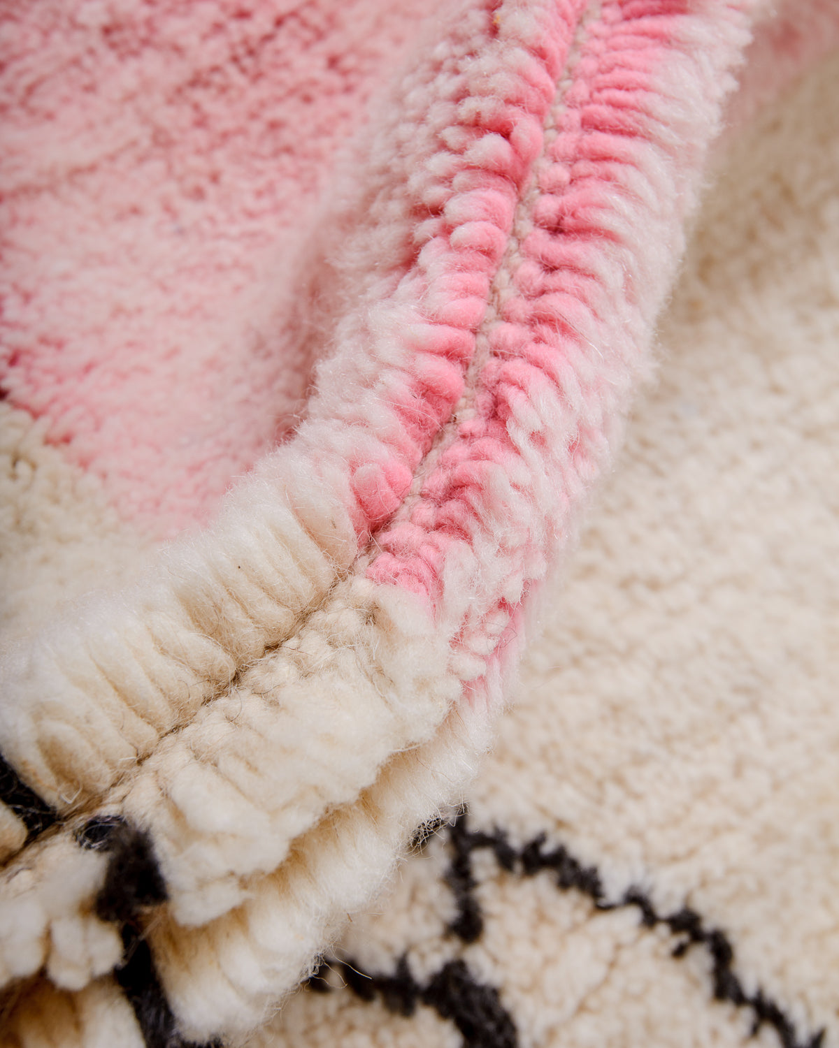 Detail of Berberlin finest Beniourain rug showing thick wool pile and dense knots.