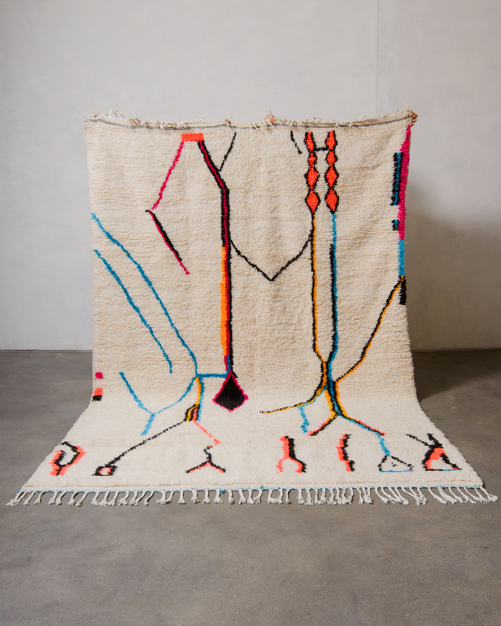 Decorative Azilal rug with bold abstract pattern on a plain background.