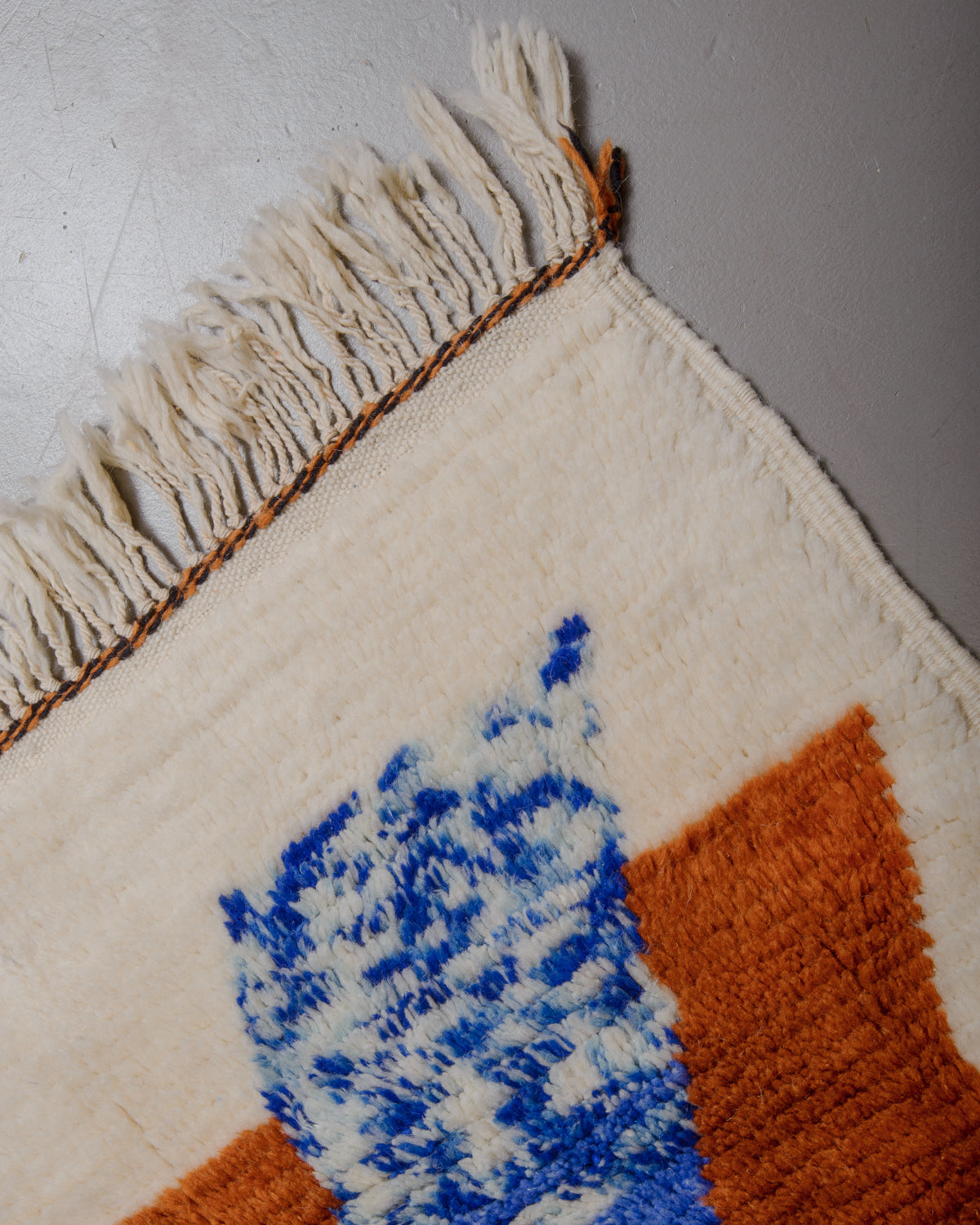 Edge of azilal rug with wool tassels. 