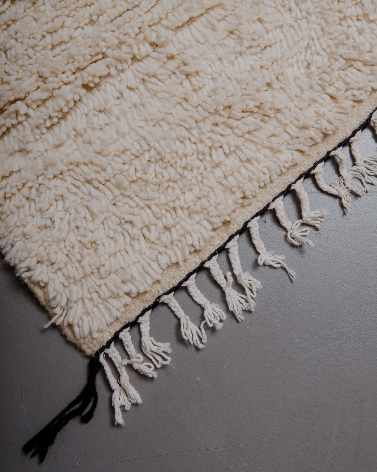Corner of azilal rug with cotton tassels. 