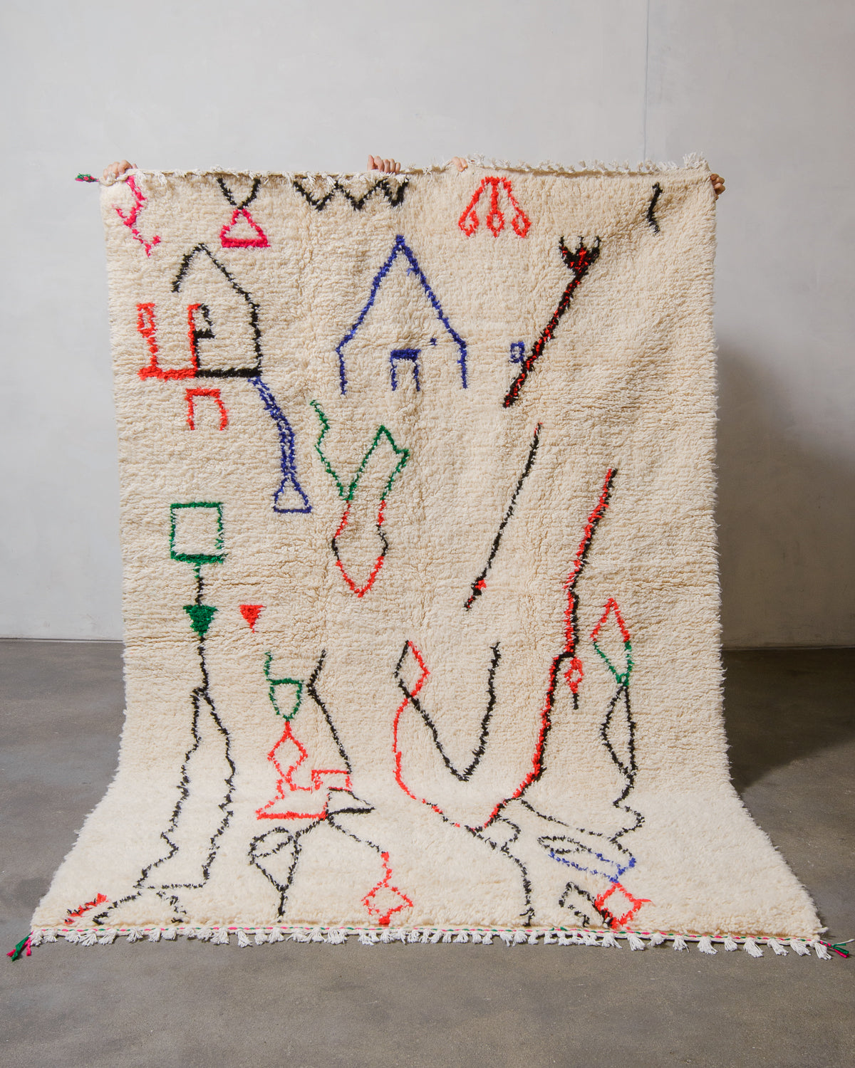 Decorative Azilal rug with colourful geometric pattern on a plain background.