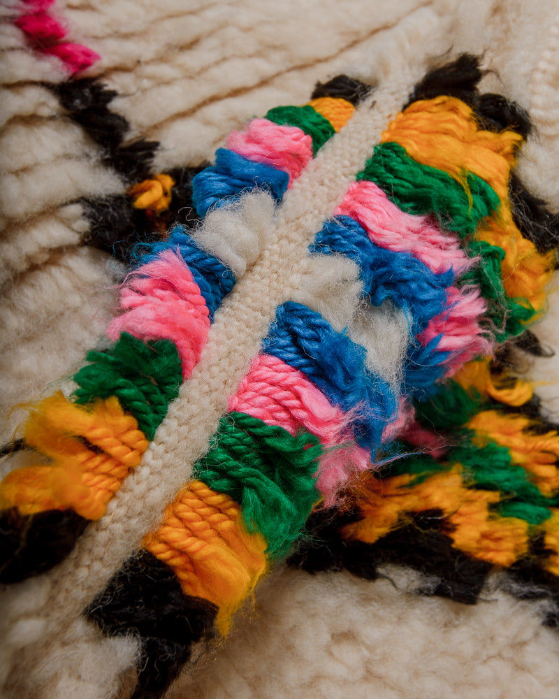 Close-up of azilal rug made of cream wool and colourful cotton.