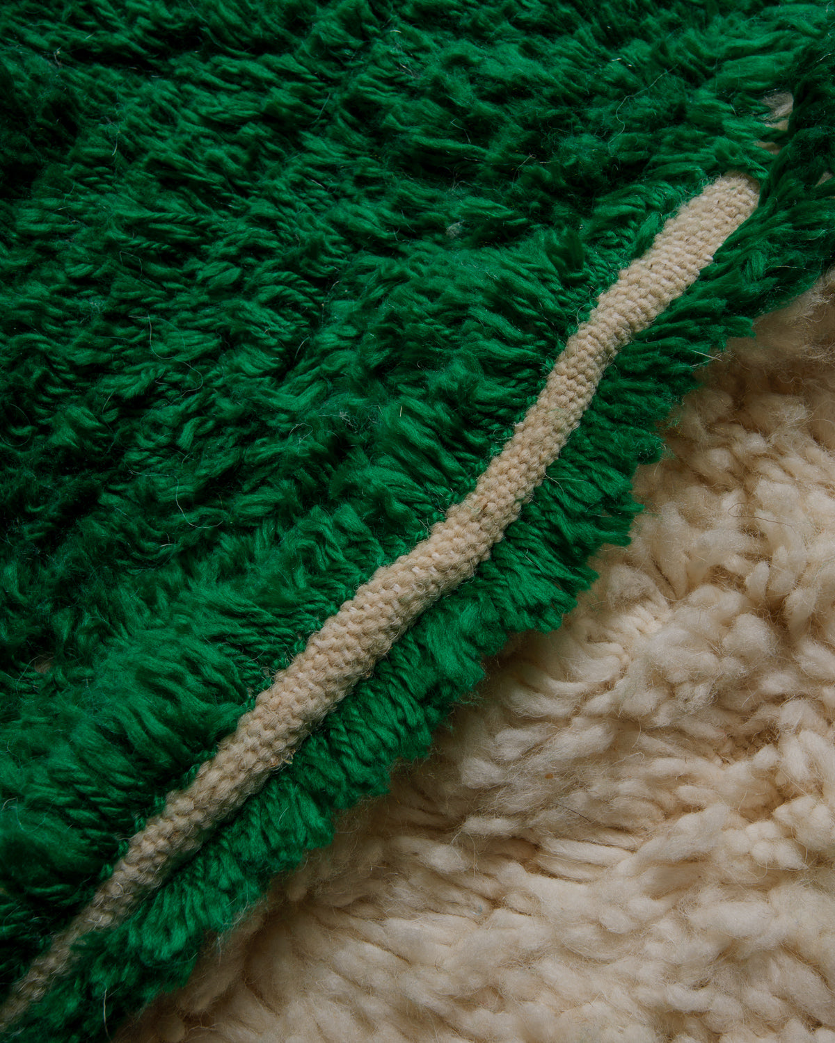 Close up of Azilal rug with cream wool and forest green cotton.