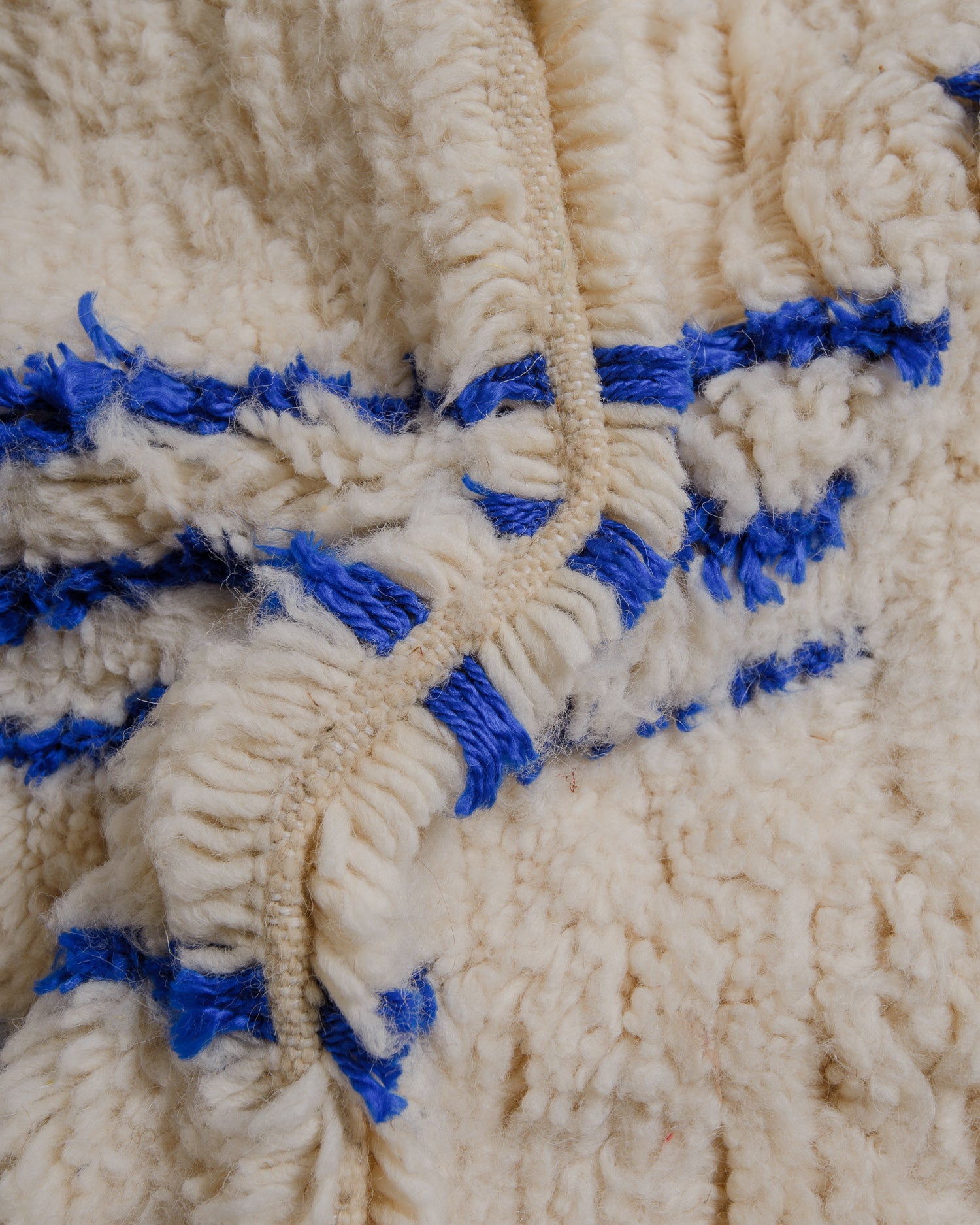 Close up of cream azilal with blue design elements.